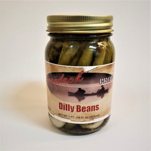 Glass jar of Dilly Beans with green beans showing through the jar around the label under the gold screw top.
