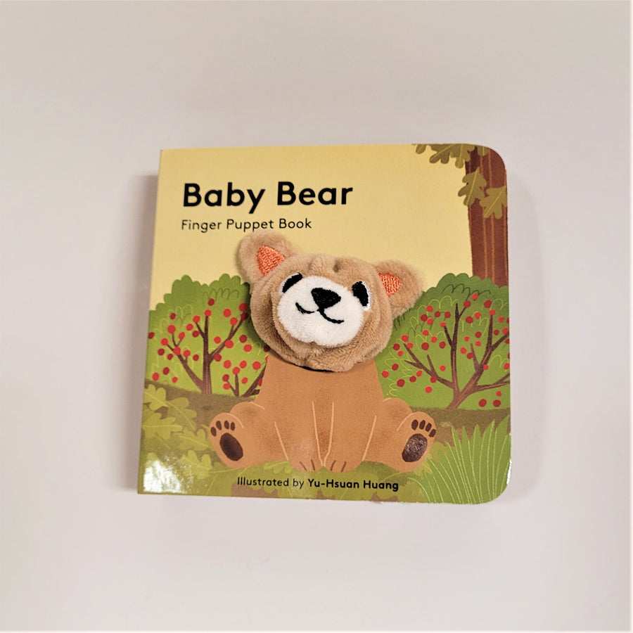 Baby Bear finger puppet book with cloth head of bear coming out of the flat book cover. Bear is beige with brown and black accents placed in front of apple trees.