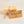 Single bar of Goat's Milk Orange soap standing upright with beige twine circling the center holding the beige label.