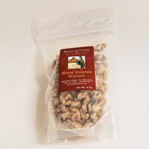 Standing bag of Mapleland Farms Maple Roasted Walnuts with label top-centered and Walnuts showing through the clear plastic bag.