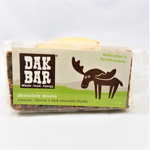 The chocolate moose Dak bar standing upright with some of the bar peeking through the bottom and left side of the packaging.