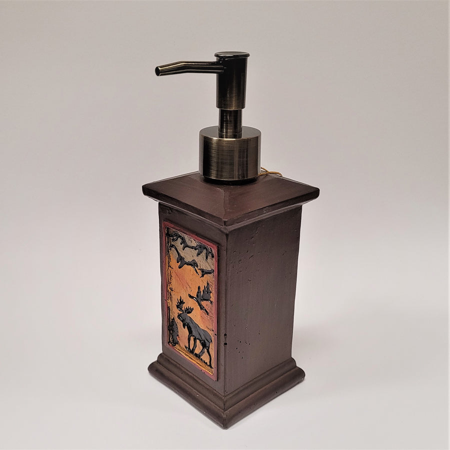 Moose soap dispenser seen angled with the solid colored side in full view and the amber moose scene in diagonal to the left.