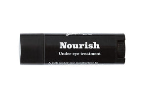 Closed cylinder of Nourish Under eye treatment. White type of the black label, resting flat on its back on a white background.