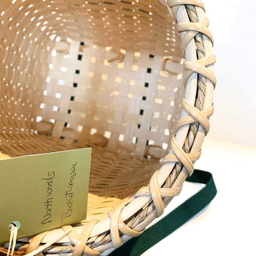 A look inside a Northwoods Basketweaver basket revealing weaving pattern and criss cross edging on rim