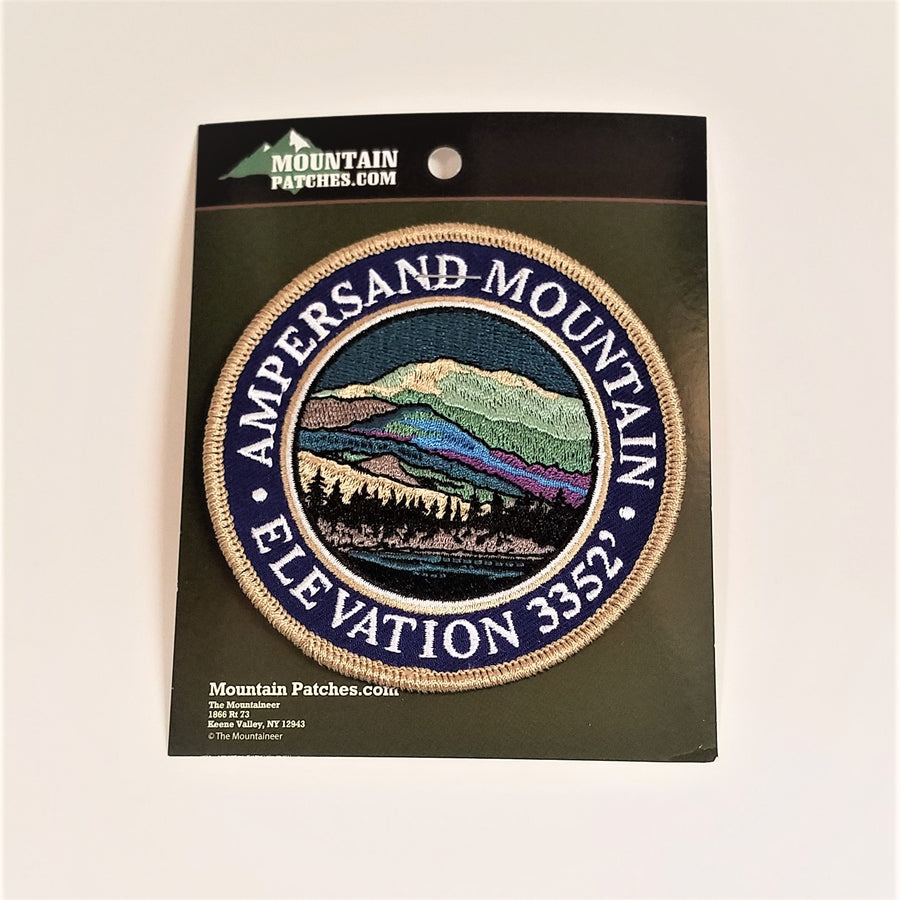 Single patch with  a navy circle border and white embroidered text reading AMPERSAND MOUNTAIN ELEVATION 3352, with mountain scene embroidered in circle in a circle.
