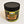 Nacho-You Mama's gourmet peanut butter in its plastic jar with a black screw lid. Eagles and forest are featured on the label surrounding the type.
