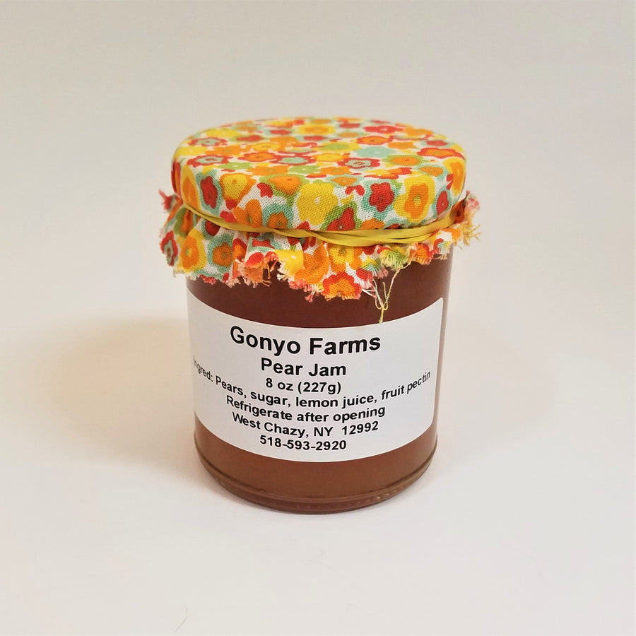 Colorful yellows and orange flowered cloth banded to a jar of Gonyo Farms Pear Jam.