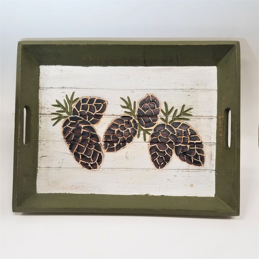 Green trim-edged tray with white base and 6 pine cones depicted on surface.