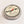 Single tin of Rescue Me sitting flat on a white surface. Silver circular tin with a compass-face look on the inner top circle. Black type on the label says SallyeAnder Rescue me For distressed skin Intensive care balm