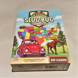 Cover of Jr. Ranger Slug Bug State-Cation Card Game lying flat depicting a colorful map of the USA with iconic images placed on some of the state; a red Volks bug, a moose and two pine trees.