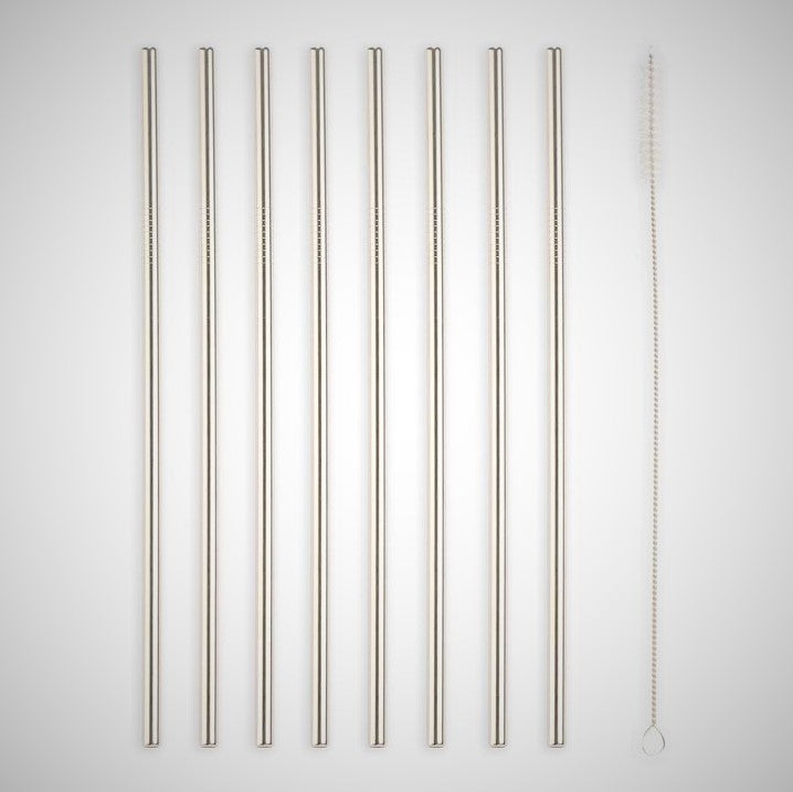 8 stainless steel straws standing upright next to the straw cleaner.