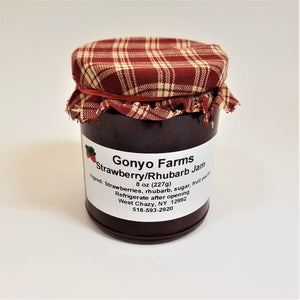 Red and beige plaid cloth banded to a jar of Gonyo Farms Strawberry/Rhubarb Jam