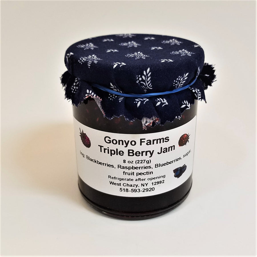 Blue cloth with white spray pattern banded to a jar of Gonyo Farms Triple Berry Jam