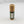 Cardboard lipstick-shaped container of VAPOR RUB standing upright.
