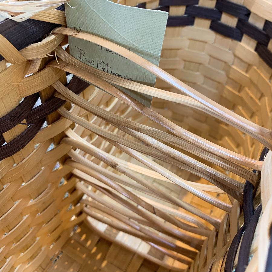 The inside of a woven wine basket with the woven bottle separation featured.