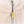 Zipper with lure fish zipper pull attached. Lure is green, yellow and orange with black dots on the left side in the green and yellow section.