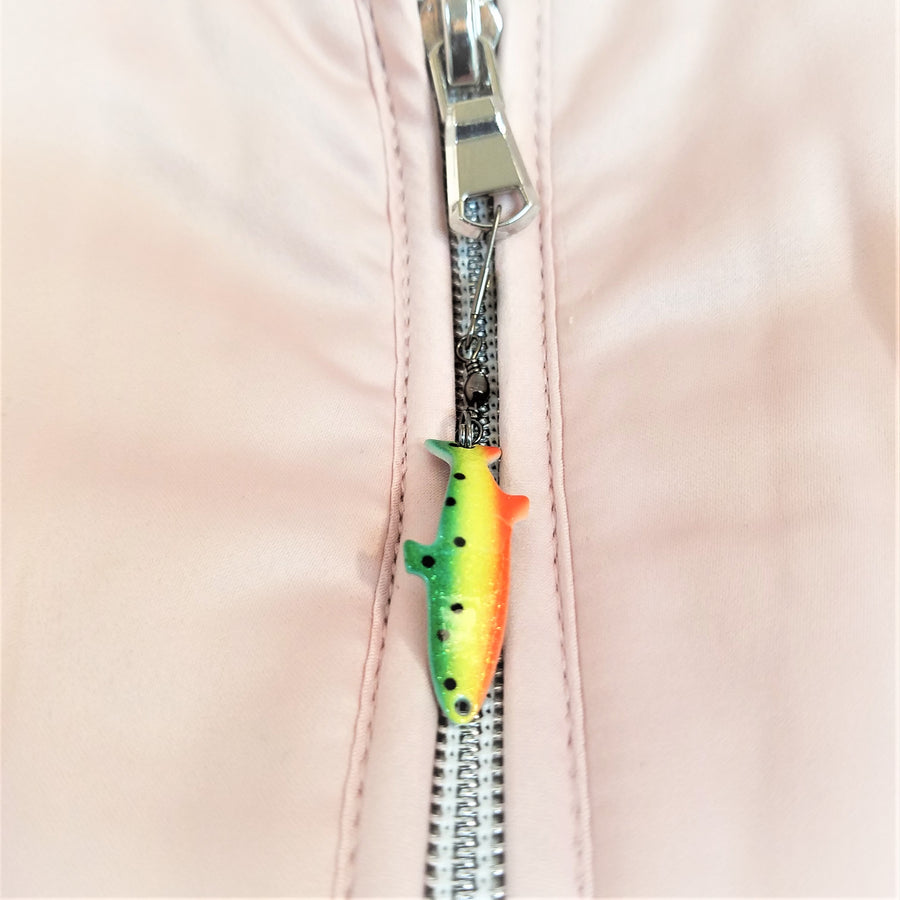 Zipper with lure fish zipper pull attached. Lure is green, yellow and orange with black dots on the left side in the green and yellow section.