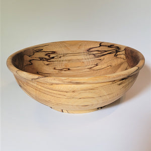 Wood bowl on a white background. Wood grain insdie and outside the bowl is visible.