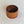 Darker wood end grain bowl standing straight up on a white background. The inside of the bowl looks very dark from this perspective.