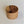 Ligher wood end grain bowl standing straight up on a white background. The inside grain of the bowl can be clearly seen.