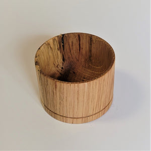 Ligher wood end grain bowl standing straight up on a white background. The inside grain of the bowl can be clearly seen.