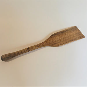 Single dark-grain wood spatula on a white background.
