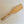 Single light wood-grain spatula on a white background.