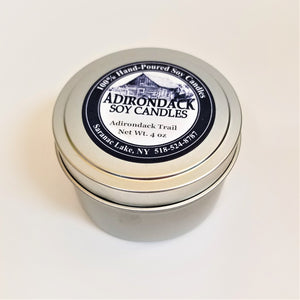 One closed 4-ounce tin of Adirondack Trail soy candle