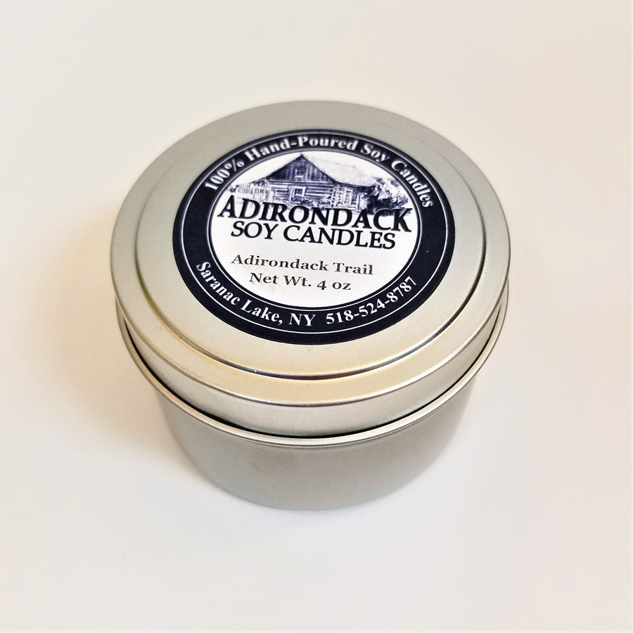 One closed 4-ounce tin of Adirondack Trail soy candle