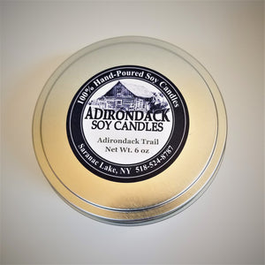 Close up on top of tin cover of 6-ounce Adirondack Trail soy candle.
