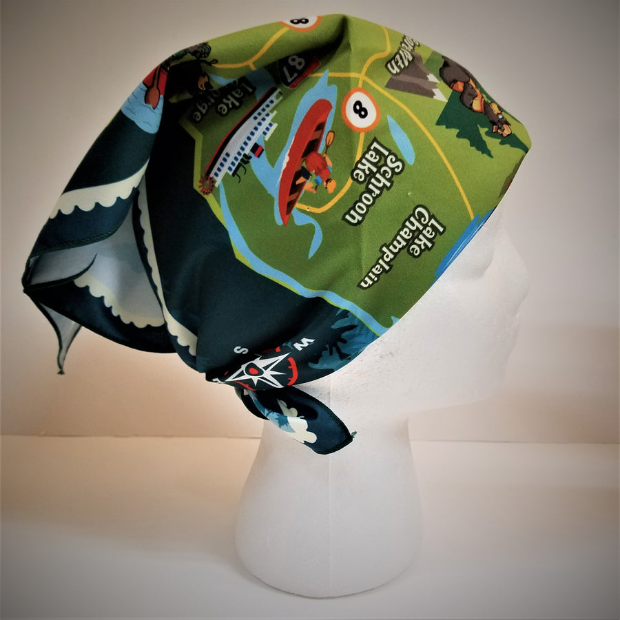 Adirondack map bandana tied on a mannequin head displaying a bright green section with a red kayak and dark green border.