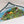 Adirondacks printed at the top triangle of this folded bandana with dark green border around a brightly colored map of icons and towns in the Adirondack mountains