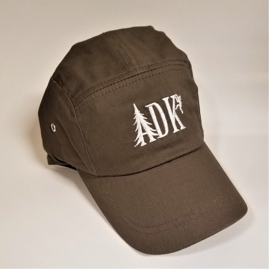 ADK panel cap in brown with white embroidery featuring the letters ADK with the A in the style of a pine tree and a small hiker climbing the top of the K