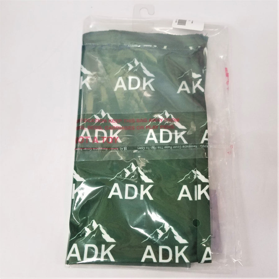 Green neck gaiter folded into rectangle in clear plastic packaging. 