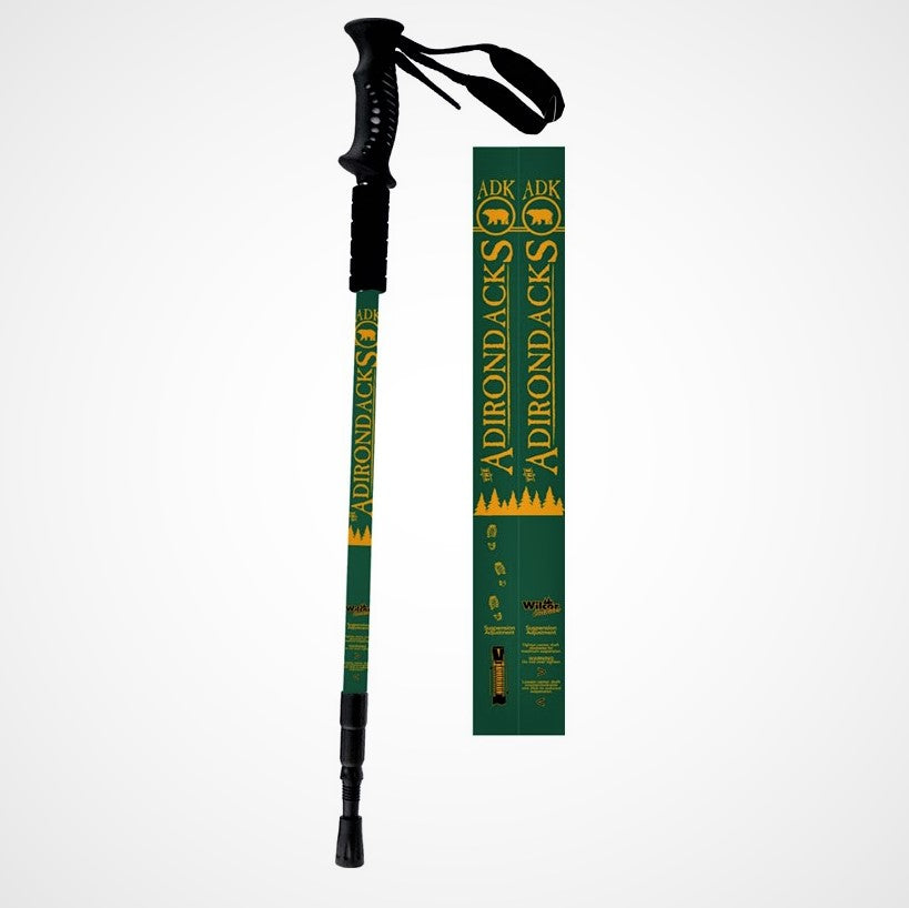 Full hiking pole with black handle and strap, green body with yellow text and symbols, and black bottom. Next to the pole is a close up of the design on the stick--a green background with yellow lettering and bear in circle symbol.