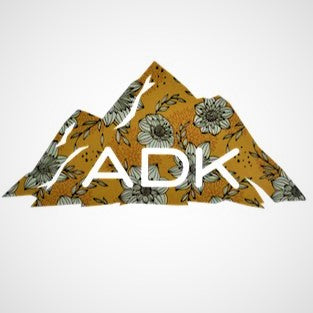 Adirondack mountain decal in yellow floral pattern with white ADK lettering printed at the base of the mountain