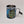 Upright metal mug with the colorful and iconic Adirondack map featured on the whole surface. a metal carabiner is on the right side in the position of a mug handle. The metal interior can be seen at the top of the mug.