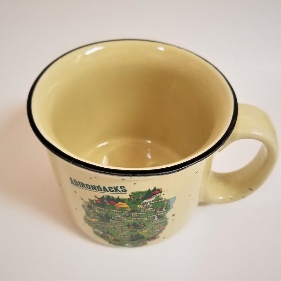 View looking down at mug with solid cream colored inside and black rim around the top. Colorful ADK park map below center on front of mug with right handle perspective.