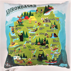 Iconic Adirondack fun map on the front of a square throw pillow. Blues surround 3 sides with white on the top. The green Park map is in the center with its colorful town depictions.