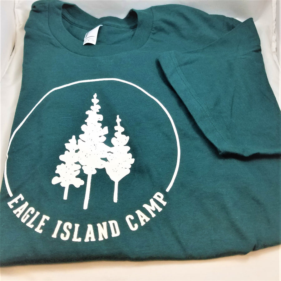 Green t shirt folded with one short sleeve folded in. White Eagle Island logo of 3 trees, inside a white semi-circle with white Eagle Island Camp lettering below.