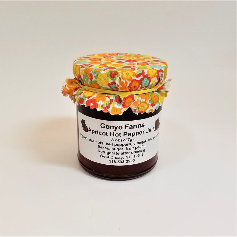 Colorful  yellows and orange flowered cloth banded to a jar of Gonyo Farms Apricot Hot Pepper Jam.