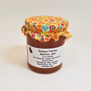Colorful yellows and orange flowered cloth banded to a jar of Gonyo Farms Apricot Jam