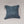 Solid light blue back of red fox pillow.
