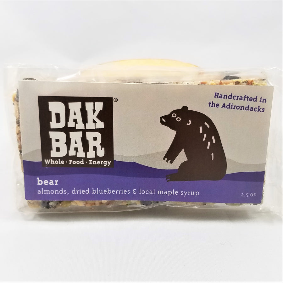 The bear Dak bar stands upright with some of the actual bar peeking through the top and bottom of the packaging.