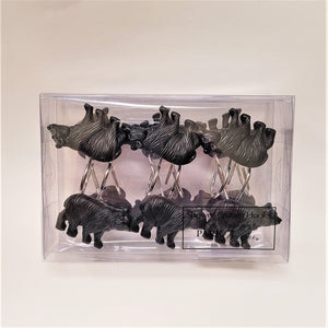 Black bear shower hooks in their plastic packaging. 6 are easily visible--3 right-side up, 3 upside down with the other 6 showing through the clear plastic.
