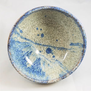 Inside ceramic bowl with blue speckled glaze and cream speckled glaze