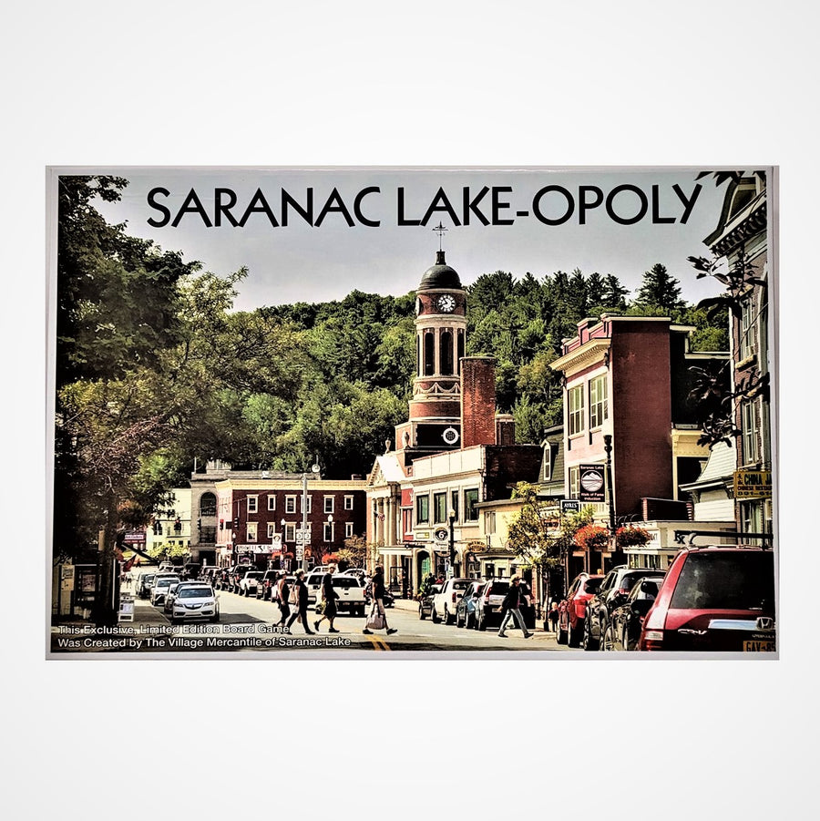 Box cover of SARANAC LAKE-OPOLY with photo of center of town taking up the full space inside a white border.