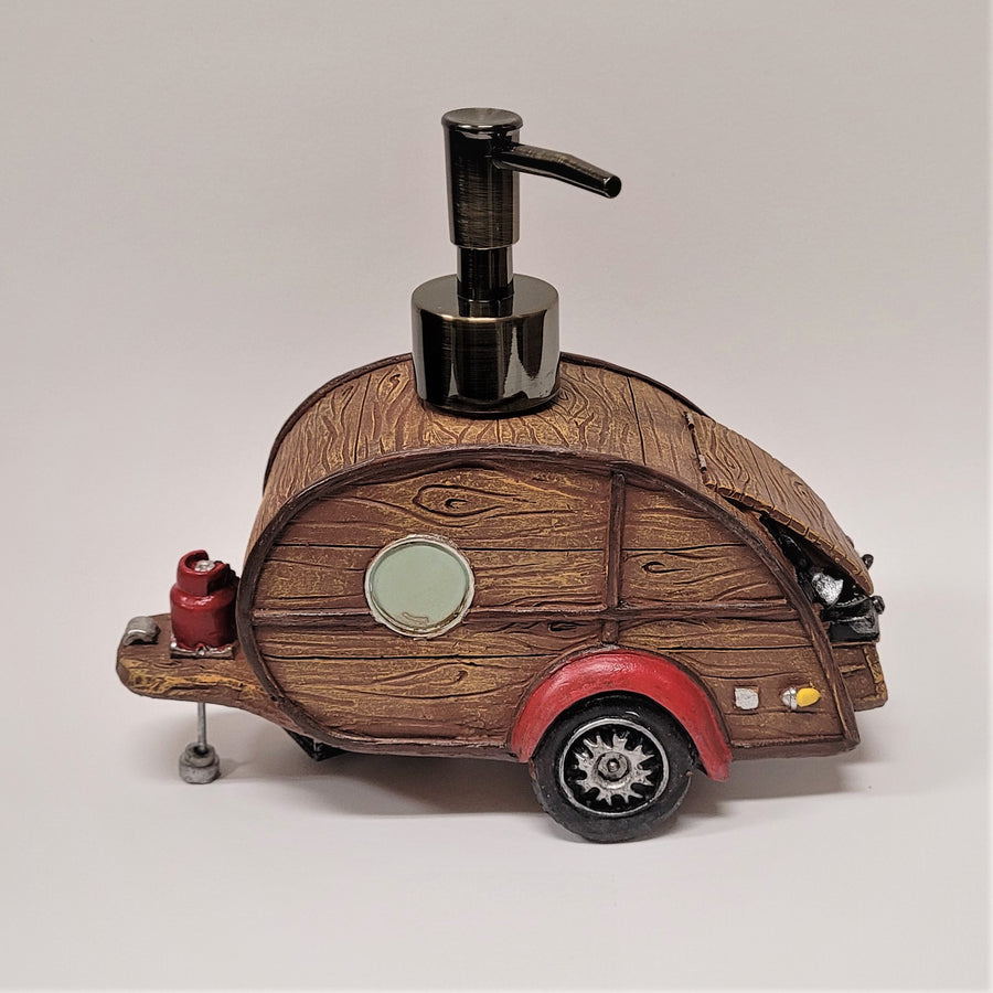 Woody camper soap dispenser in profile. The left side even includes the connection segment that leads to the pulling vehicle. the right sides shows the slightly open hatch. 