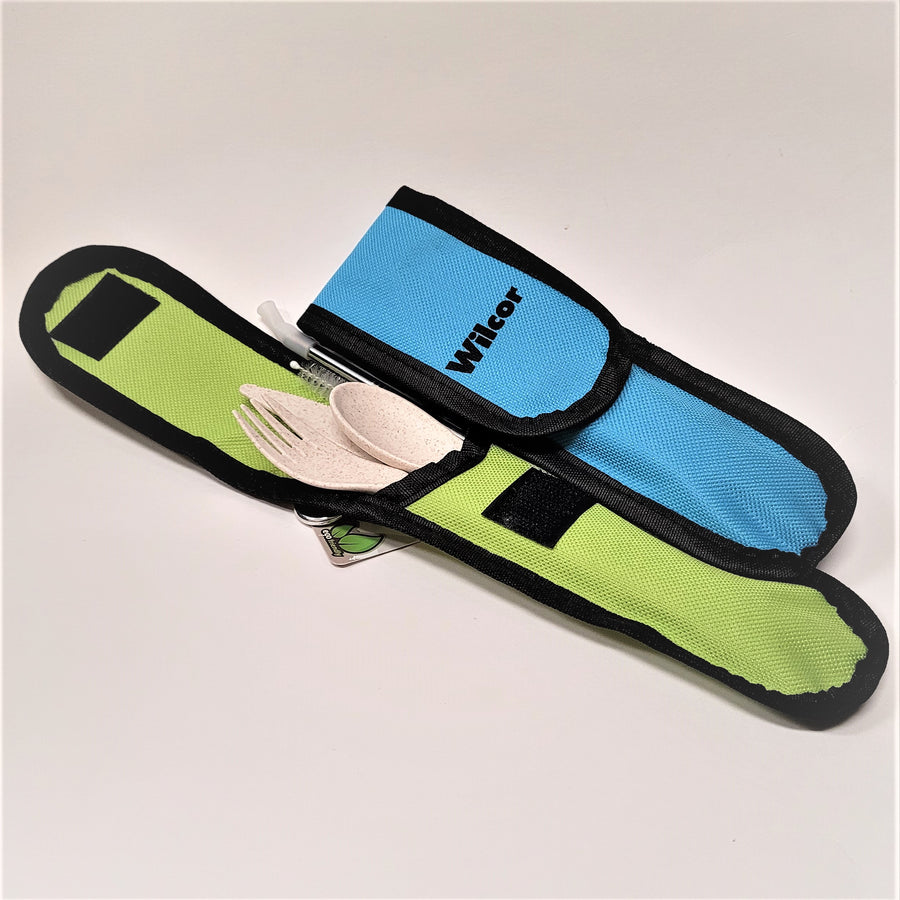 Green open pouch to the left with a wooden fork, knife, and spoon peaking through along with a straw and straw cleaner. A blue pouch is on the right, folded over so the contents cannot be scene.