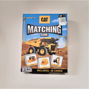 Cover of box of CAT Matching Game with photos of cards of bull dozer, hard hat and excavator on the cover .